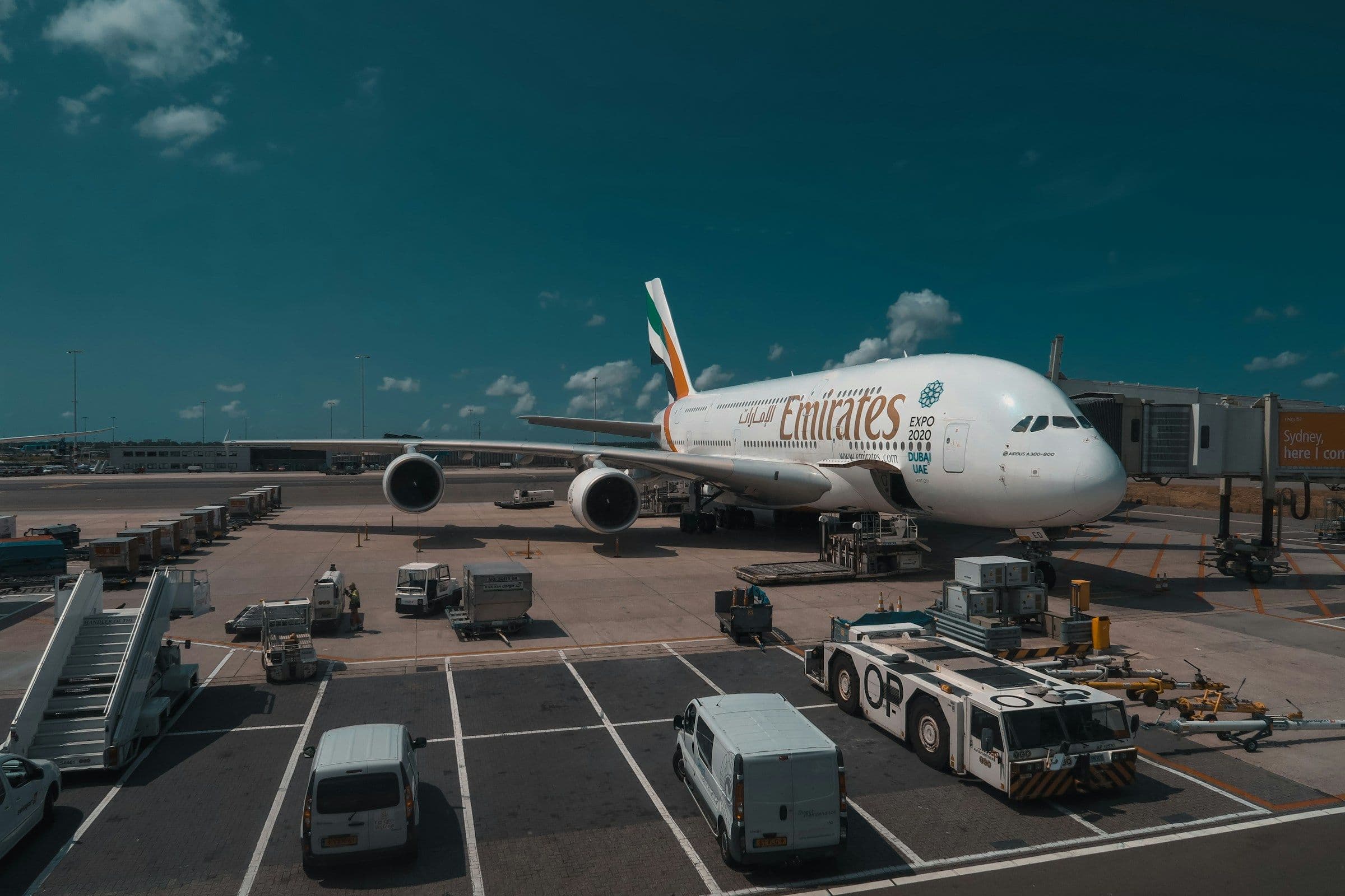 An Emirates Boeing 777 in the carrier's red, white and grey livery on a clear-sky approach.
